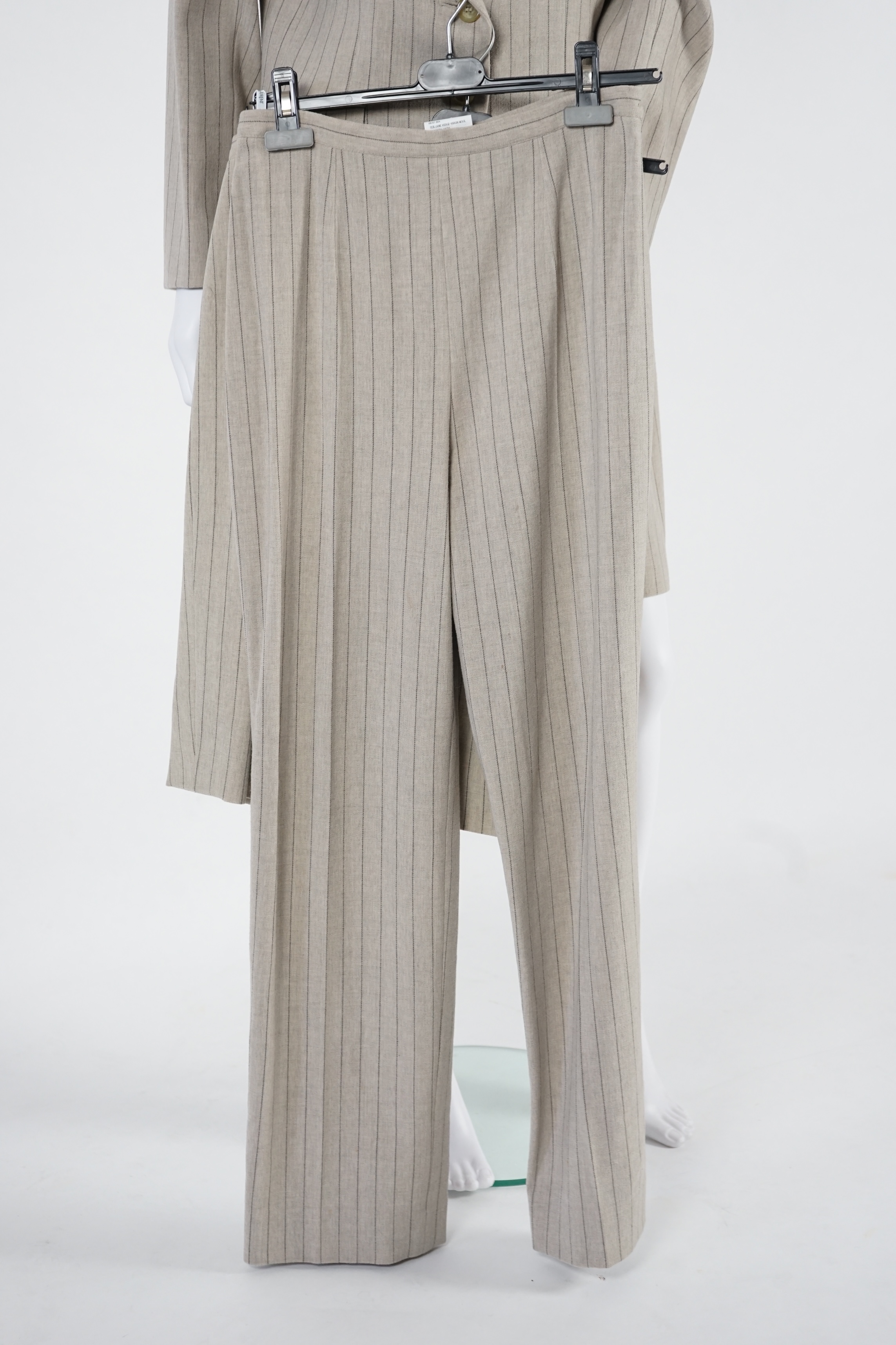 Two vintage Yves Saint Laurent variation lady's suits with matching trousers and skirts, F 40 (UK 12). Please note alterations to make the waist smaller may have been carried out on some of the skirts. Proceeds to Happy